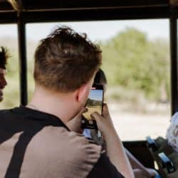 clients taking pictures of wildlife while on six on safari